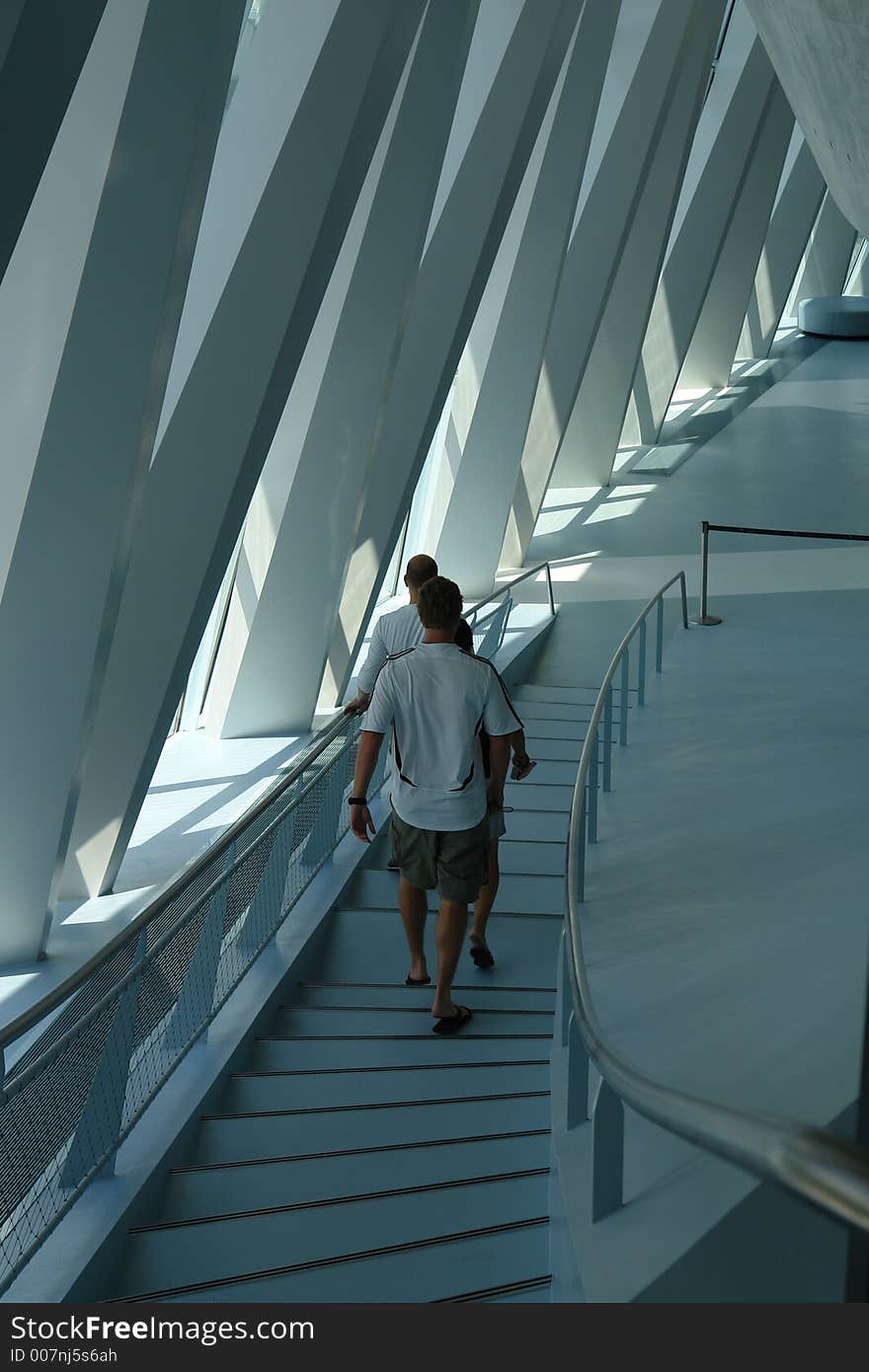 A group of people walking down a flight of stair in a modern building in Germany. A group of people walking down a flight of stair in a modern building in Germany.