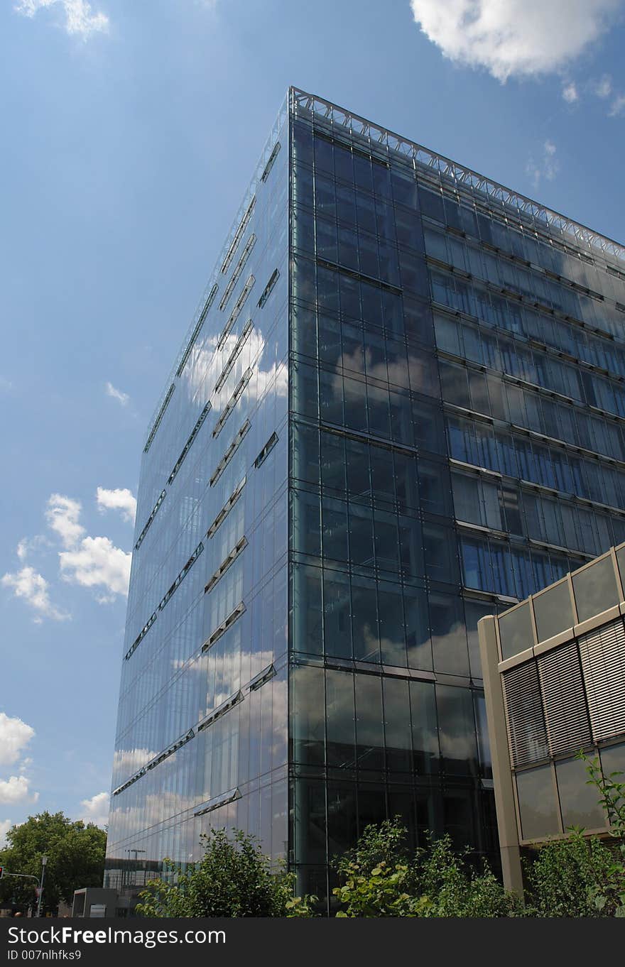 A modern glass and steel office building in a town in Germany.