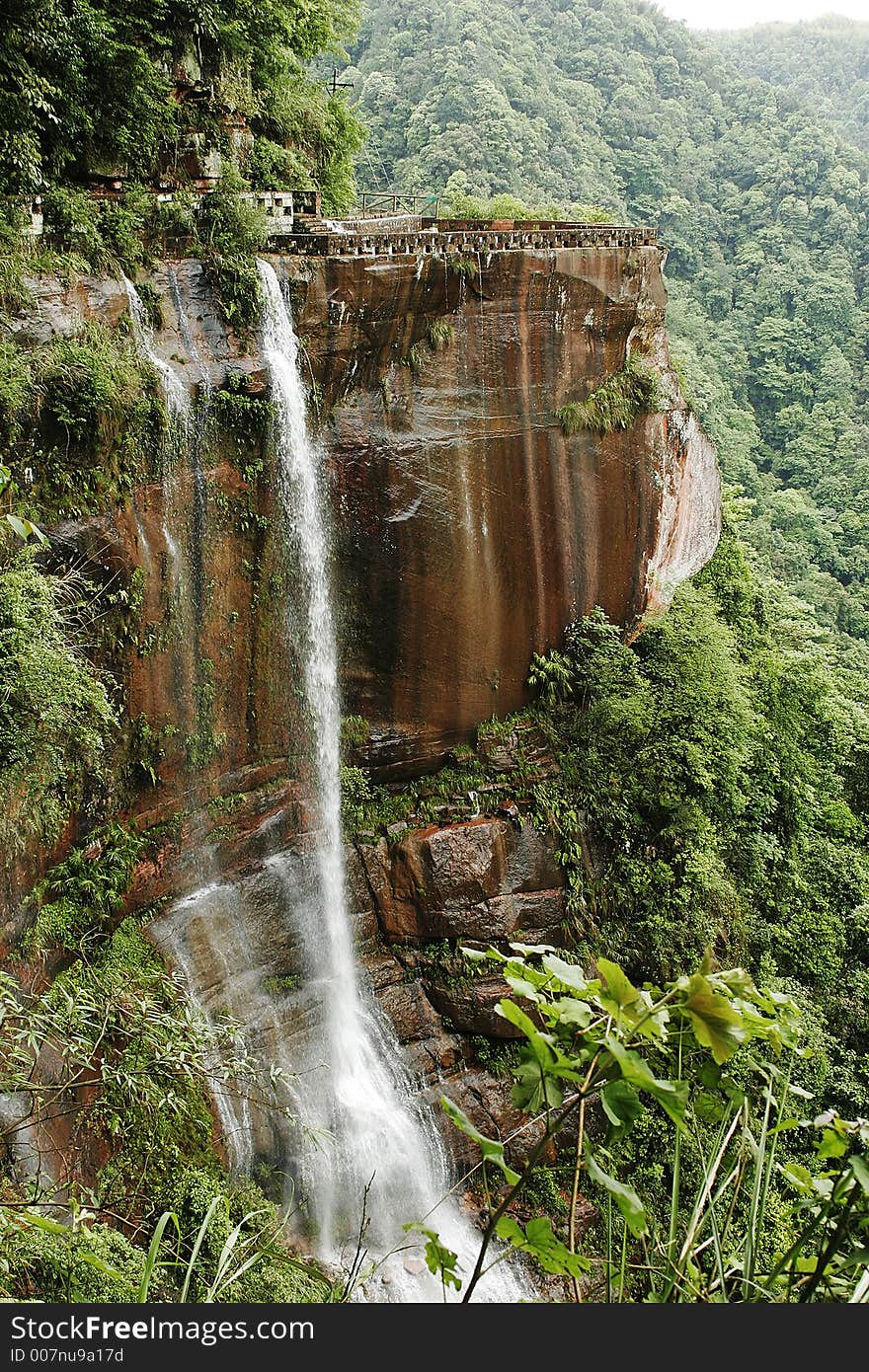 Waterfall among trees in the mountain of Sichuan province of China. Waterfall among trees in the mountain of Sichuan province of China