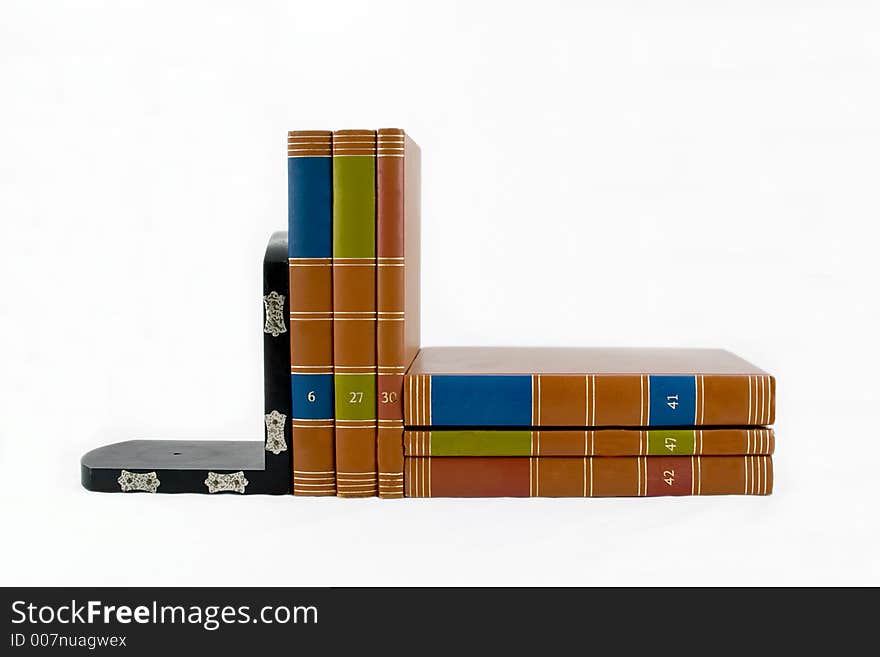 Black bookend supporting six colorful books. Black bookend supporting six colorful books.