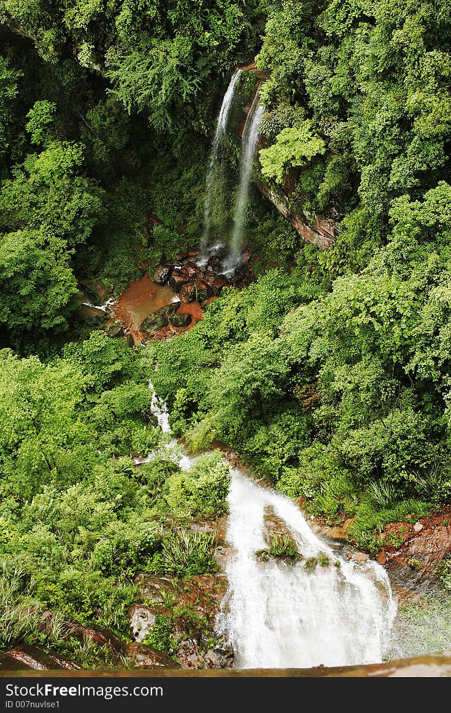 Waterfall among trees in the mountain of Sichuan province of China. Waterfall among trees in the mountain of Sichuan province of China