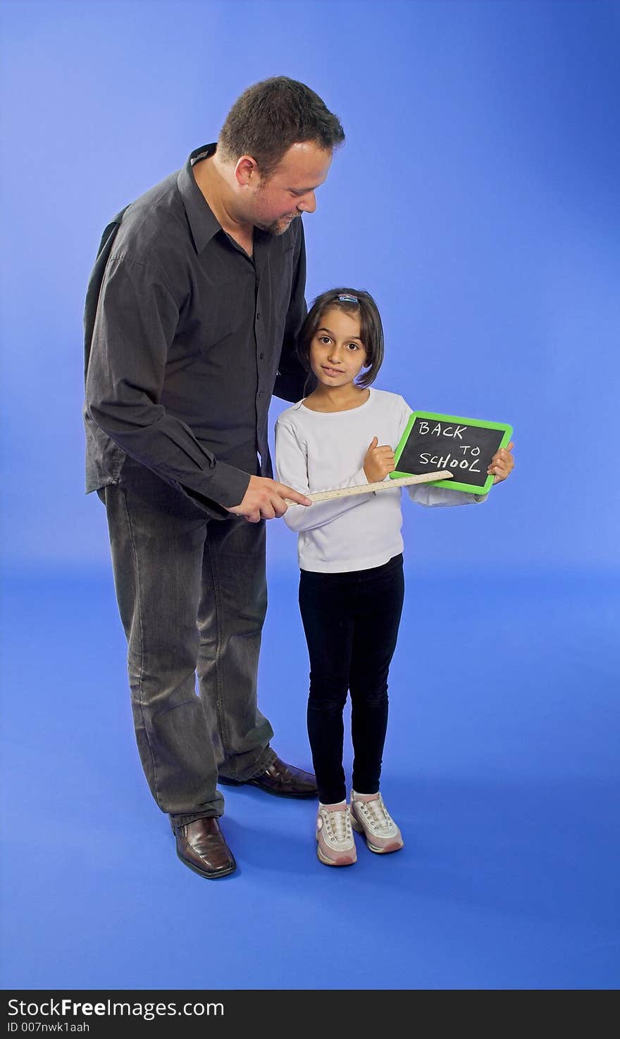 Teacher with ruler and student showing chalkboard. Teacher with ruler and student showing chalkboard