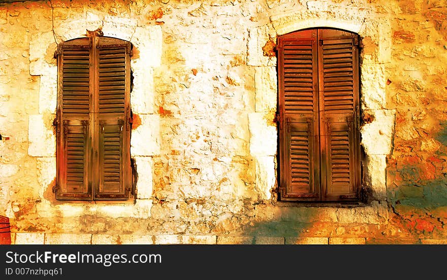 Two windows on old wall with cracks and patches in Cannes, France. Two windows on old wall with cracks and patches in Cannes, France
