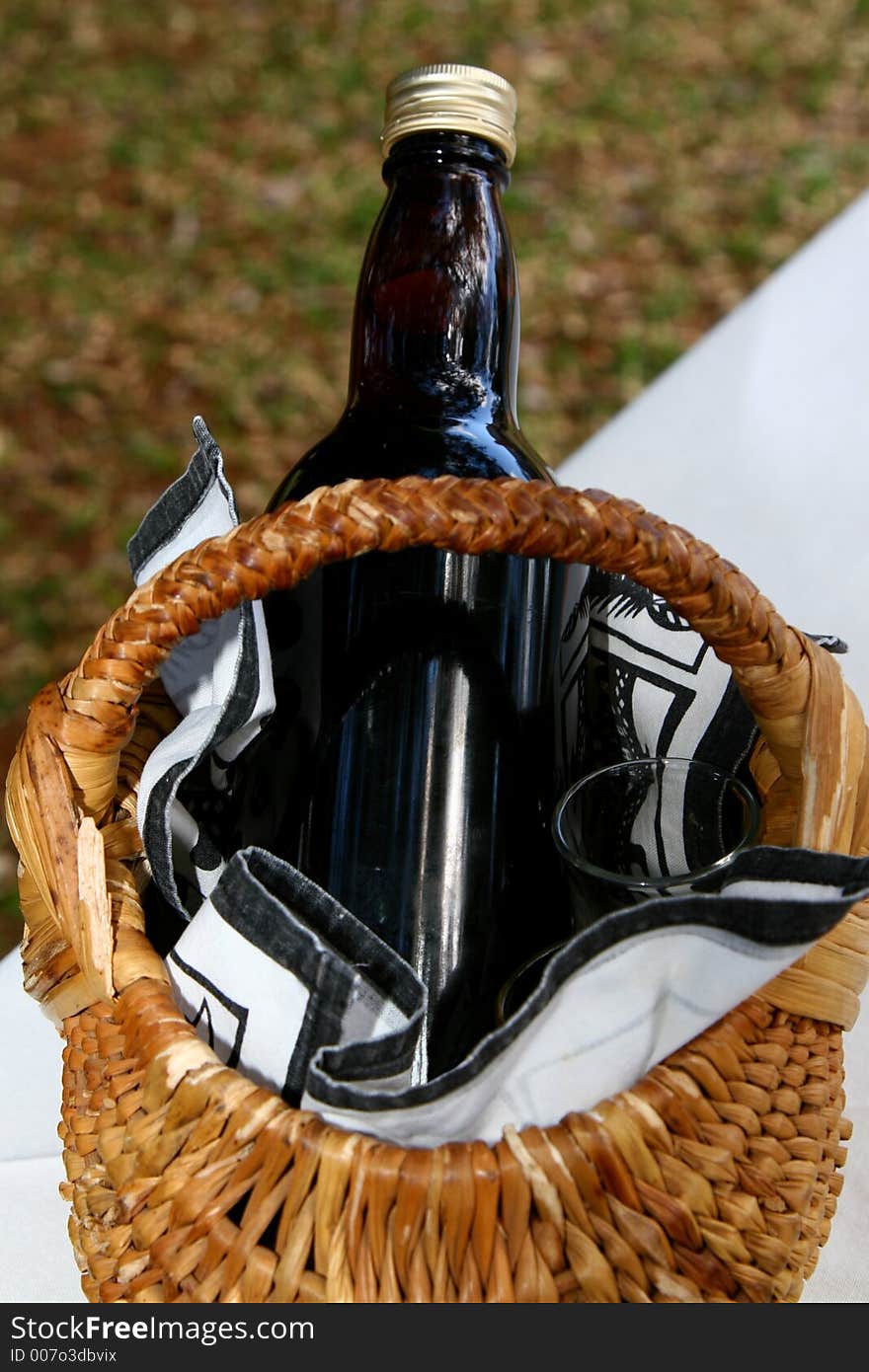 Picnic basket with bottle and glasses. Picnic basket with bottle and glasses