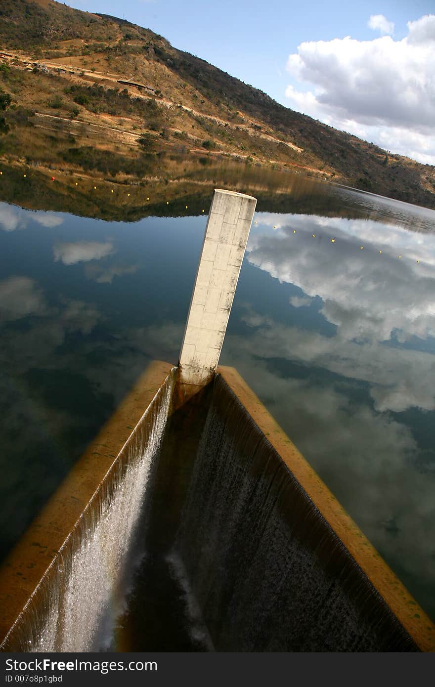 Riverbank and clouds reflecting on water. Riverbank and clouds reflecting on water