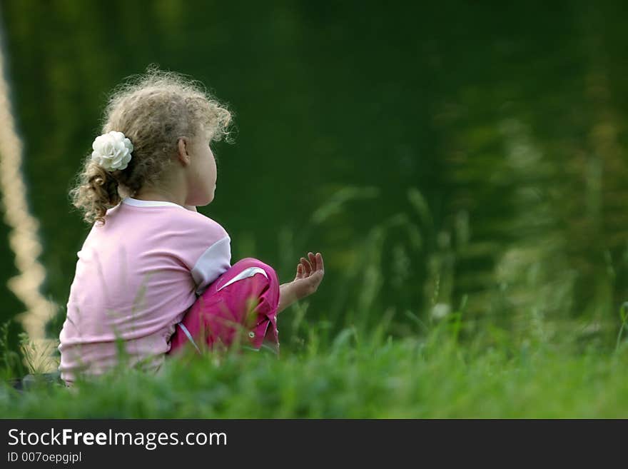 Girl on a coast of lake