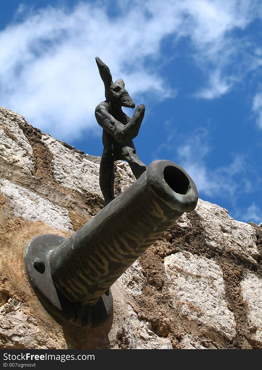 Cannon figure in a harbour wall in Spain.