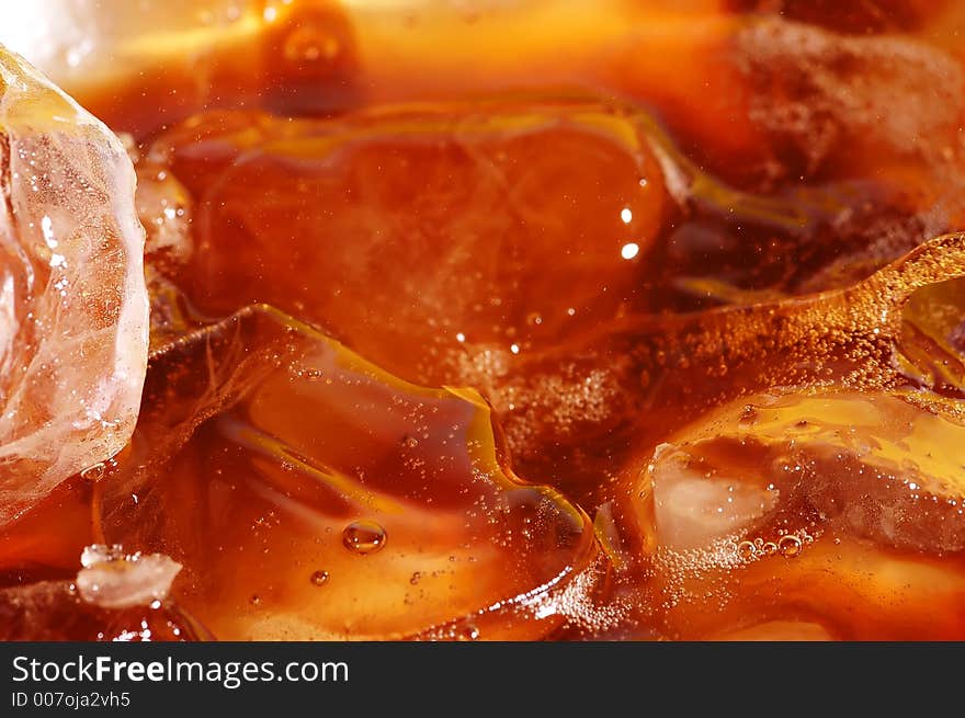 Water splash in drink with ice cubes