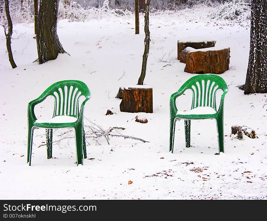 Two forgotten chairs snowed up in the woods. Two forgotten chairs snowed up in the woods