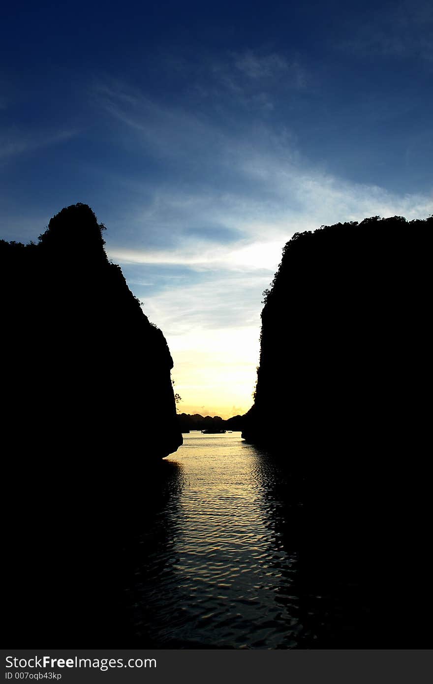 A beautiful sunset in Ha Long Bay between the rocks