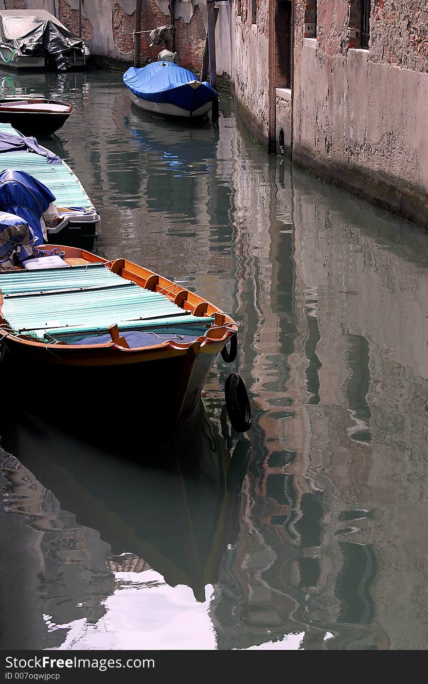 Boats on a canal in Venice. Boats on a canal in Venice.