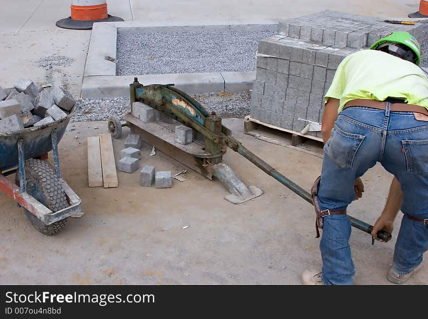 Mason Using Equipment to Cut Bricks. Mason Using Equipment to Cut Bricks