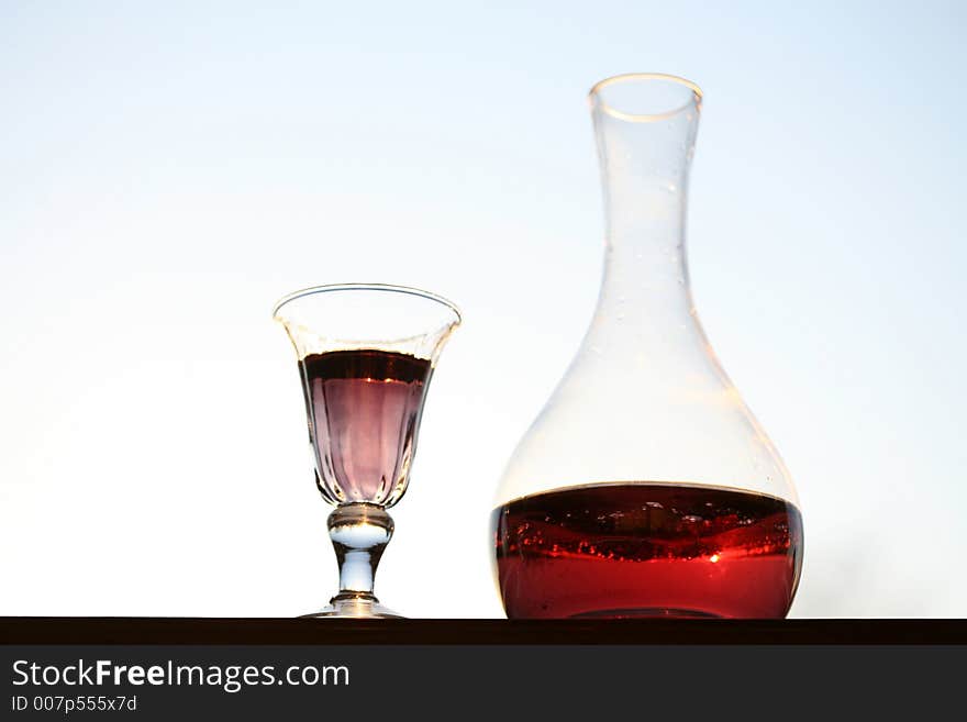 Wine glass and  bottle with light blue background