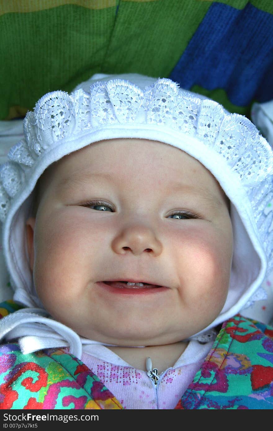 A baby girl showing her first milk teeth. A baby girl showing her first milk teeth