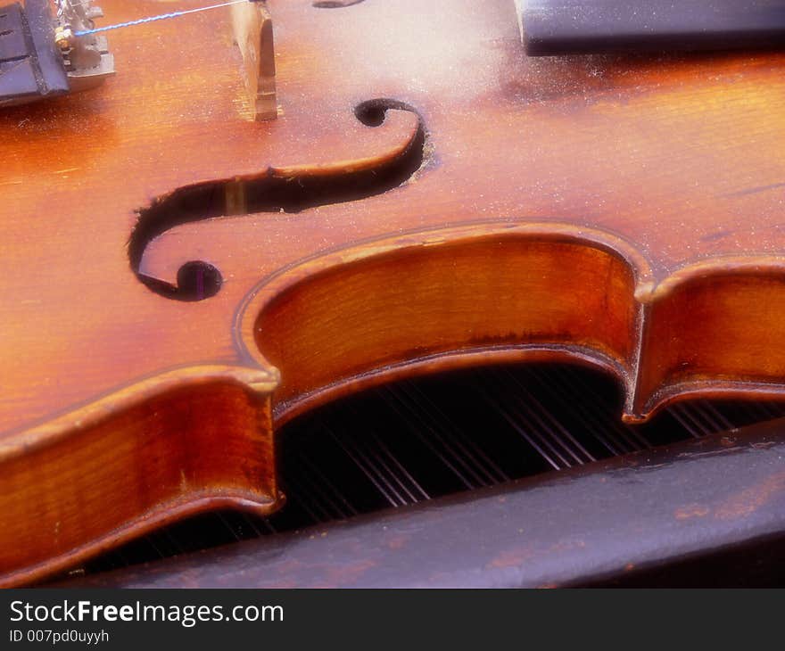 Close up to old violin with violin clef, G clef, violin key. Close up to old violin with violin clef, G clef, violin key