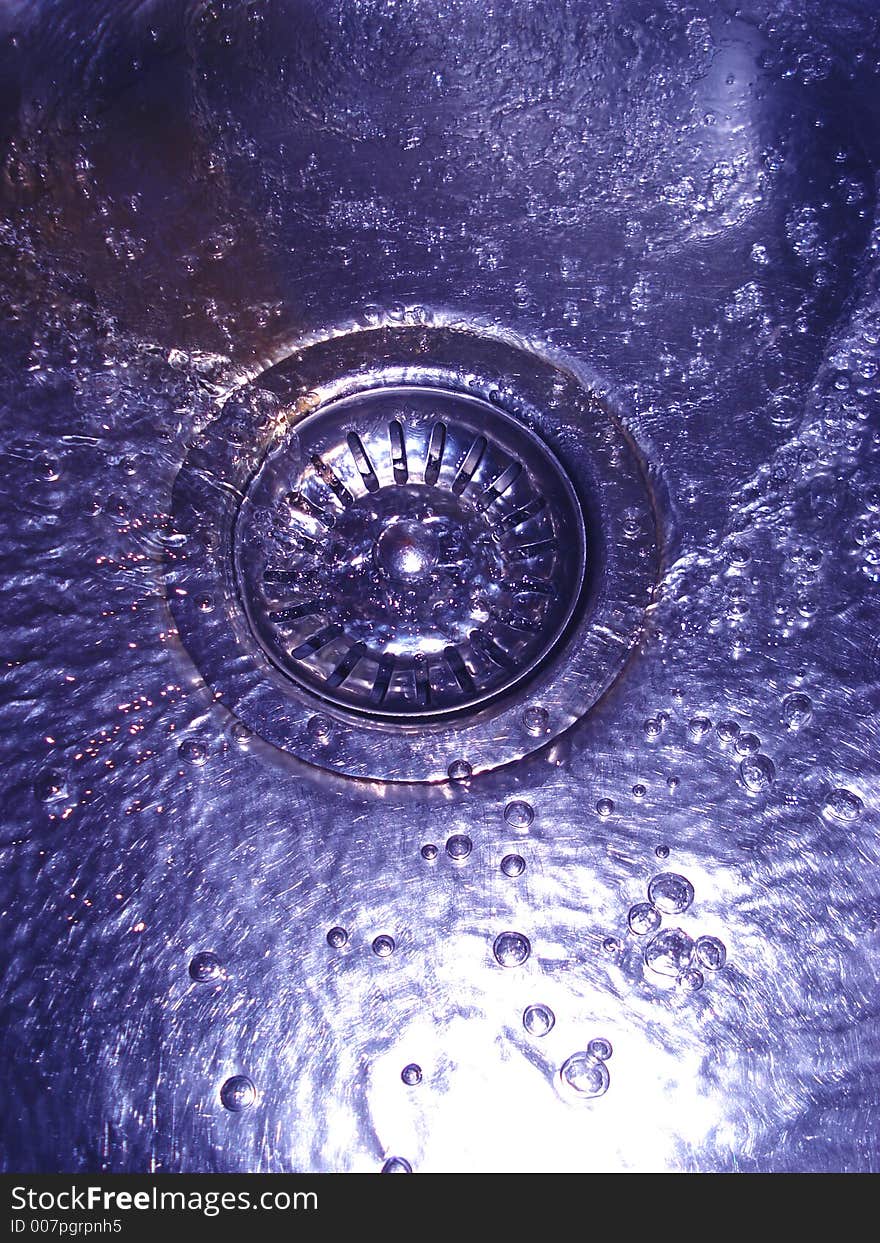 Flowing water in sink with bubbles