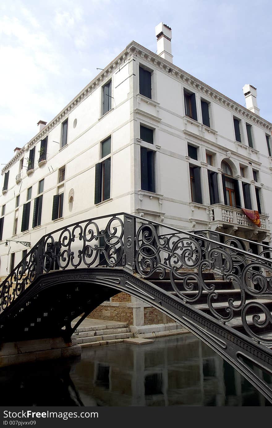 A fine iron bridge over a canal in Venice. A fine iron bridge over a canal in Venice.