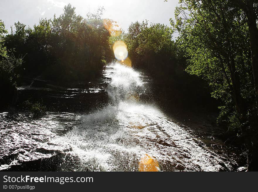 Waterfall under sunshine in the mountain of Sichuan province of China. Waterfall under sunshine in the mountain of Sichuan province of China