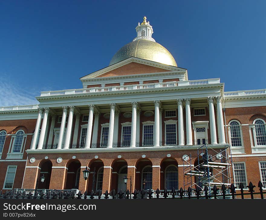 Showing Beacon street and the Massachusetts State House with a deep blue sky. Showing Beacon street and the Massachusetts State House with a deep blue sky