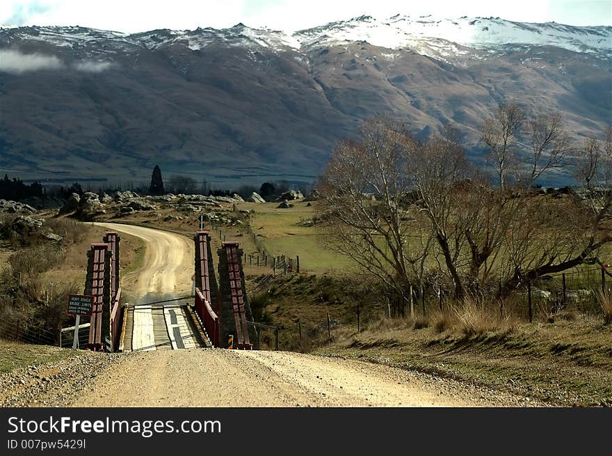 Snow covered hills with country road and bridge. Snow covered hills with country road and bridge