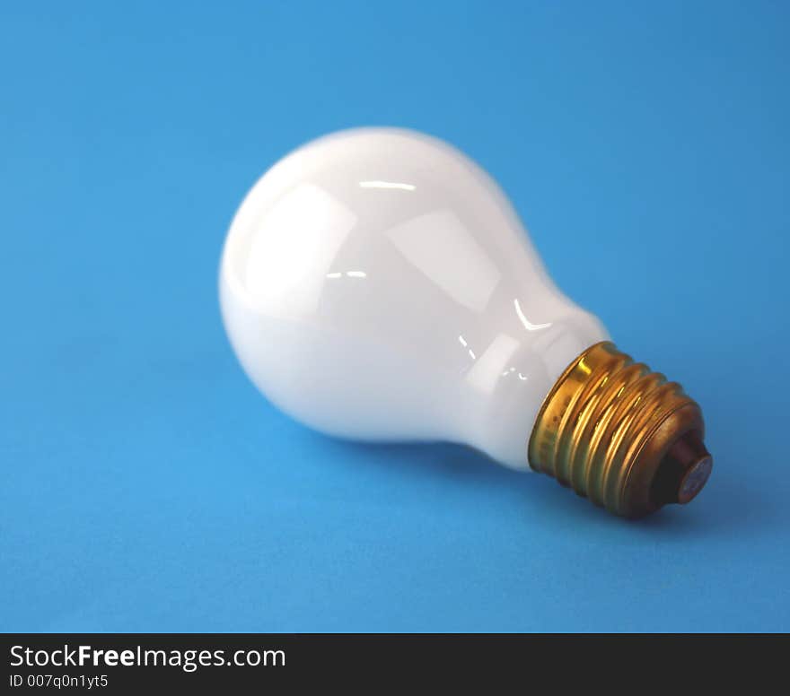 Electric Edison screw lamp on blue (focussed on screw thread)