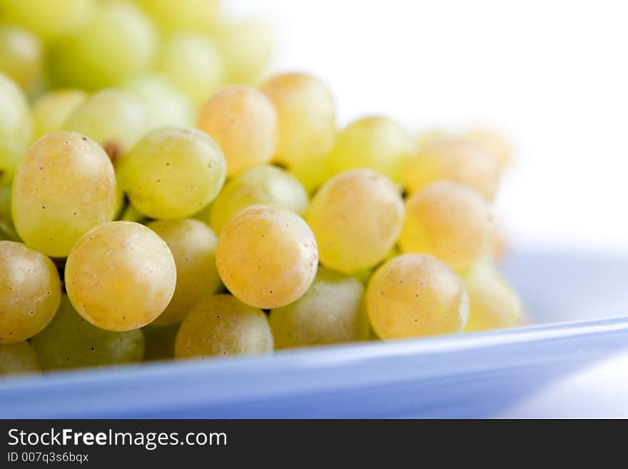 Green grape on blue dish