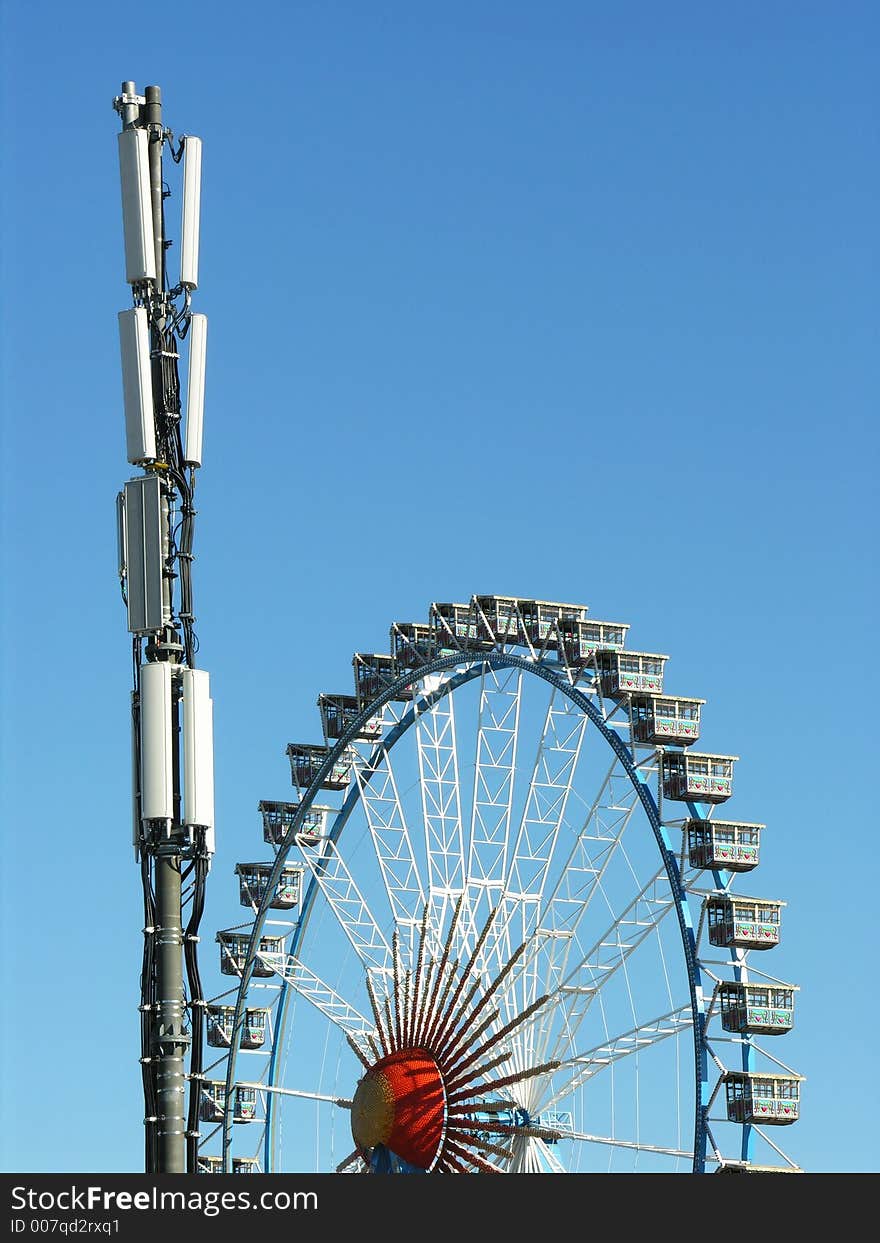 Ferris wheel and tranmitter / base station for cell phones at the Oktoberfest, Munich. Ferris wheel and tranmitter / base station for cell phones at the Oktoberfest, Munich.