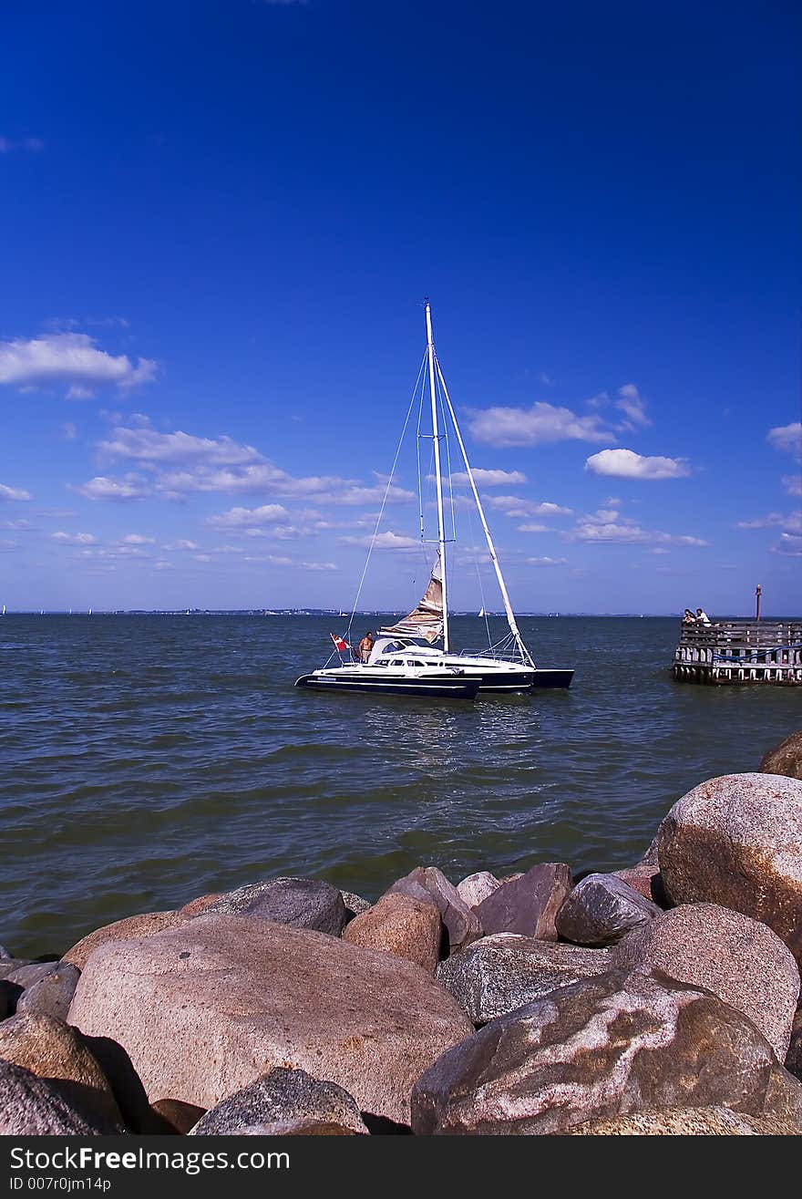 Sailboat against Blusky and small clouds.