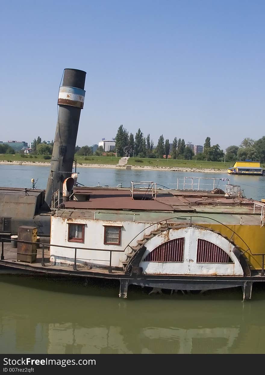 Old boat on river bank.