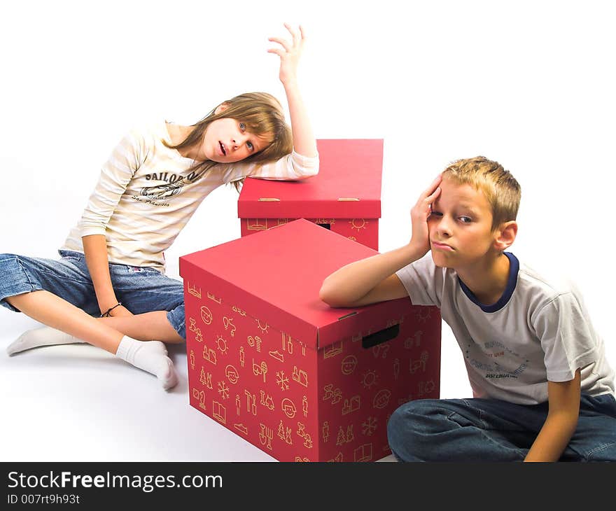 Young boy and girl on red box in white background. Young boy and girl on red box in white background