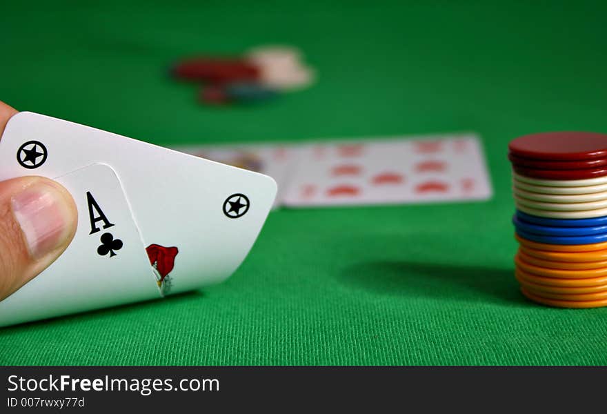 Cards held by fingers showing a royal flush. Cards held by fingers showing a royal flush