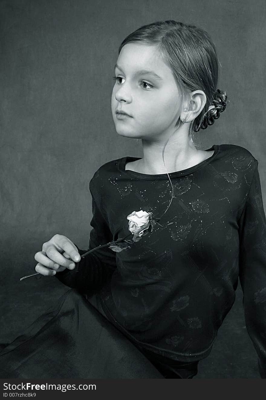 The beautiful girl with the withered flower in studio. b/w+blue tone. The beautiful girl with the withered flower in studio. b/w+blue tone