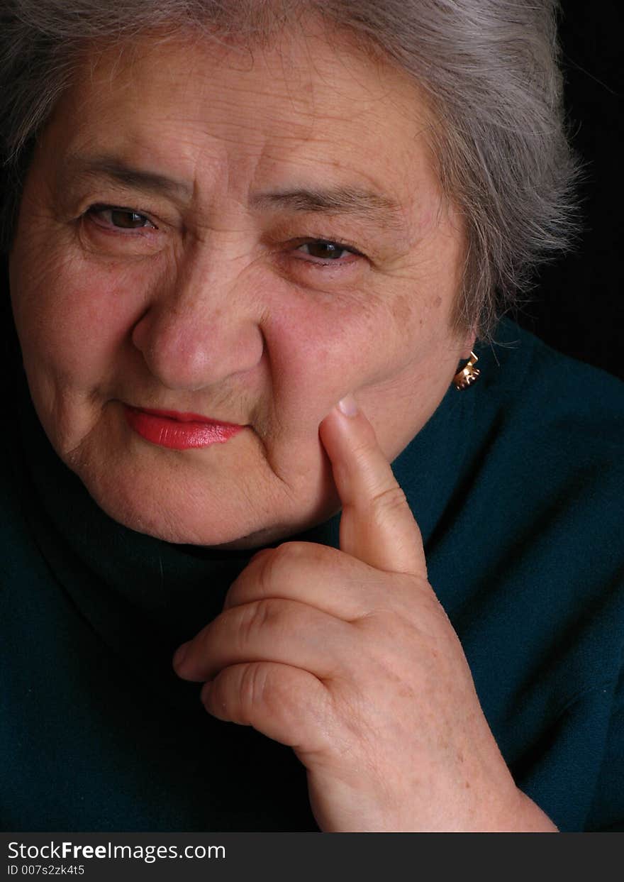 Face of aged woman who sitting on the chair and lookind