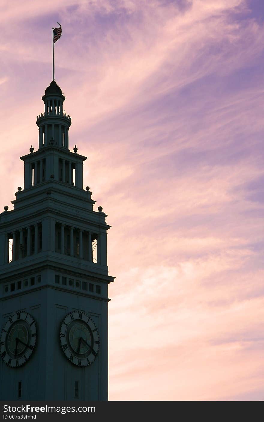 Silhoutte of a clock tower against sunset sky