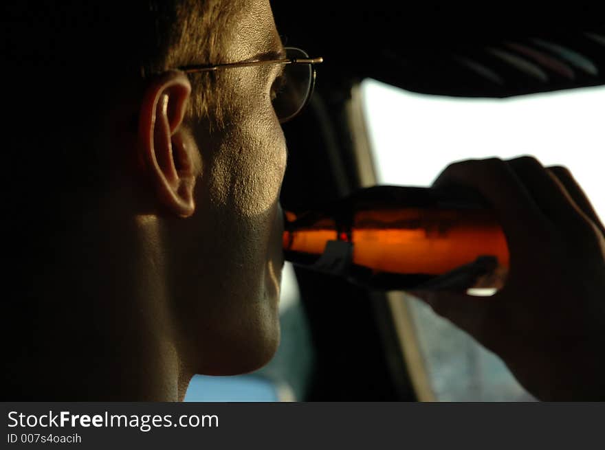 Young man drinking cold beer. Young man drinking cold beer.