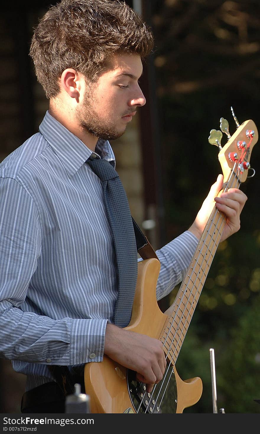 A man playing the guitar. A man playing the guitar