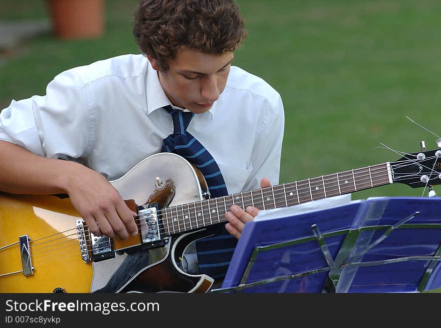 A man playing the giutar. A man playing the giutar