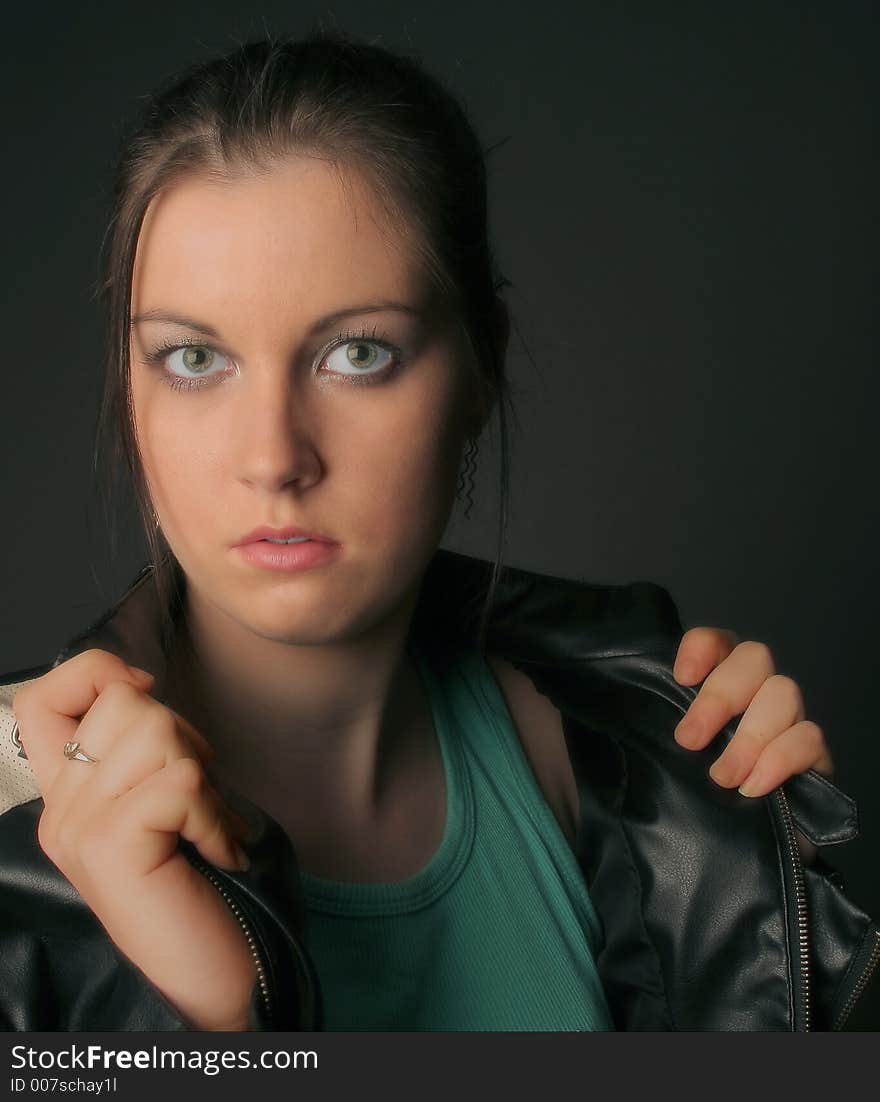 Woman with short hair and blue eyes against soft green background. Woman with short hair and blue eyes against soft green background