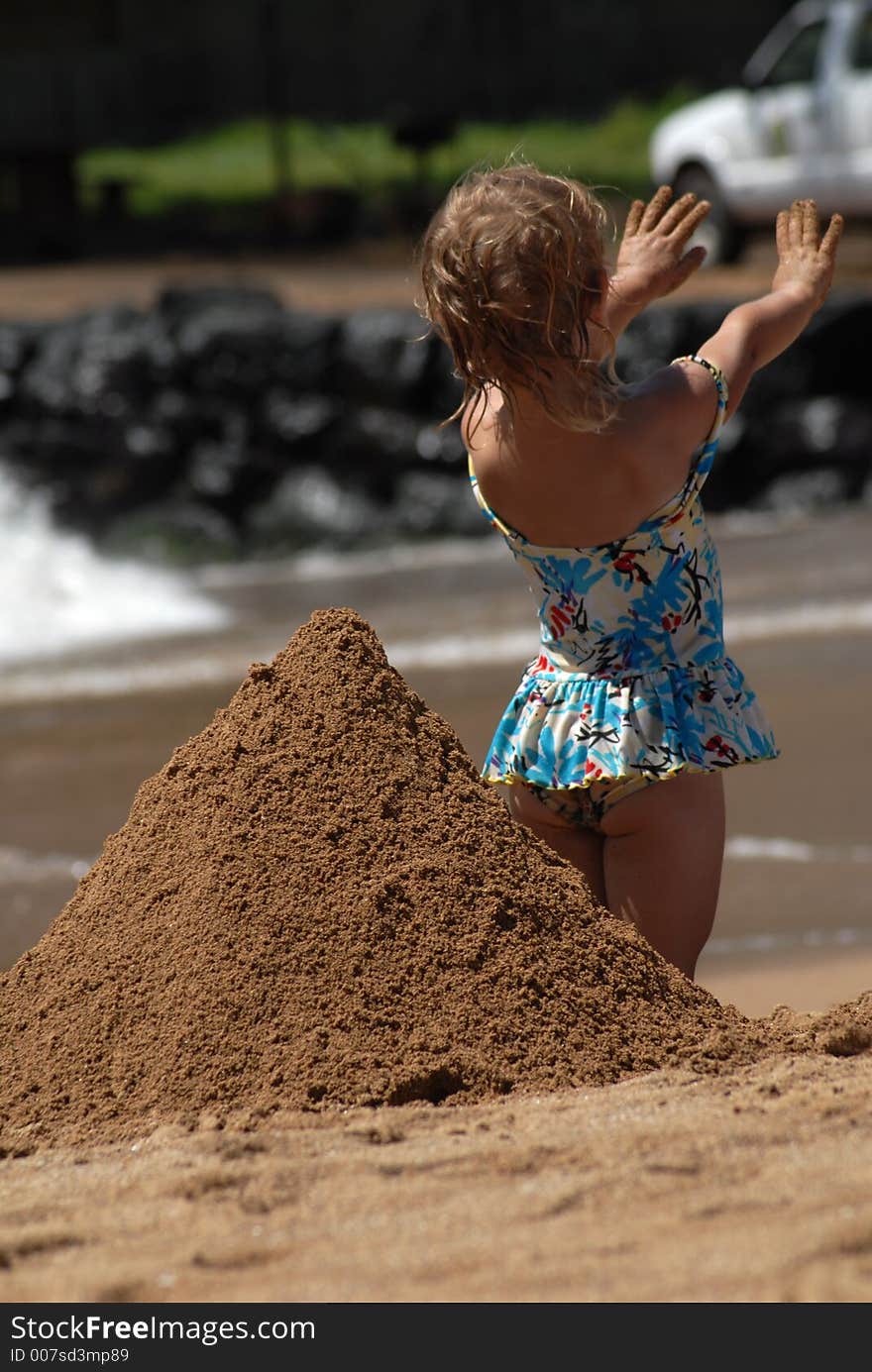 A small girl showing her dirty hands after playing in the sand. A small girl showing her dirty hands after playing in the sand