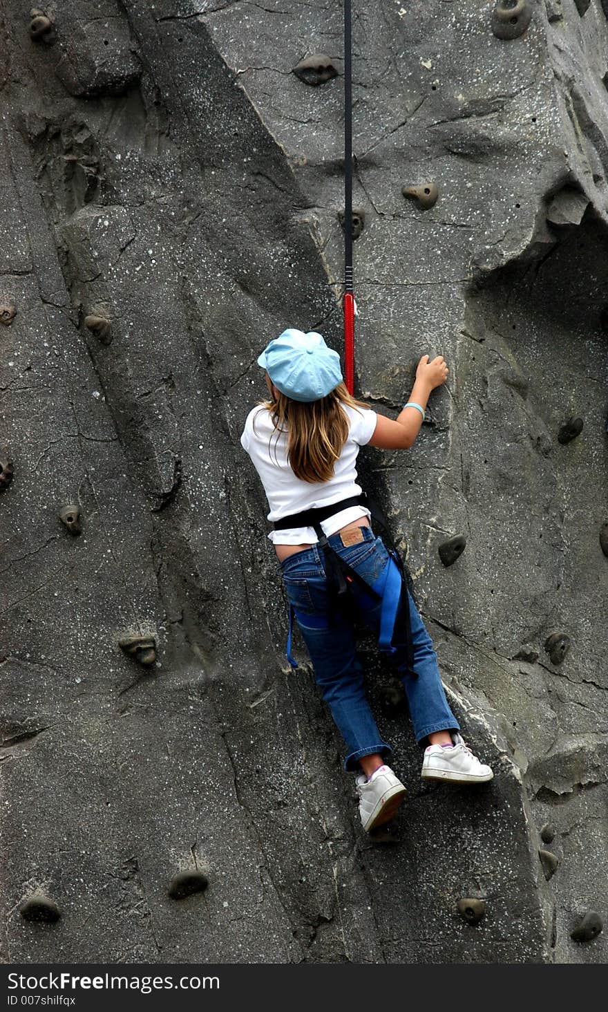 Young boy climbs to the top. Young boy climbs to the top.