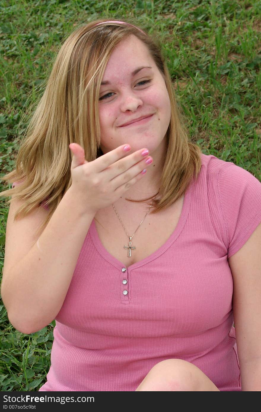 Teenage girl laughing and trying to cover her mouth. Teenage girl laughing and trying to cover her mouth.