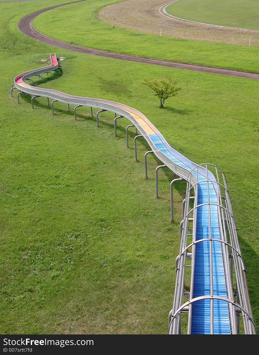 Abstract leisure park lines with a slide, jogging track ,grass field and interesting perspective.