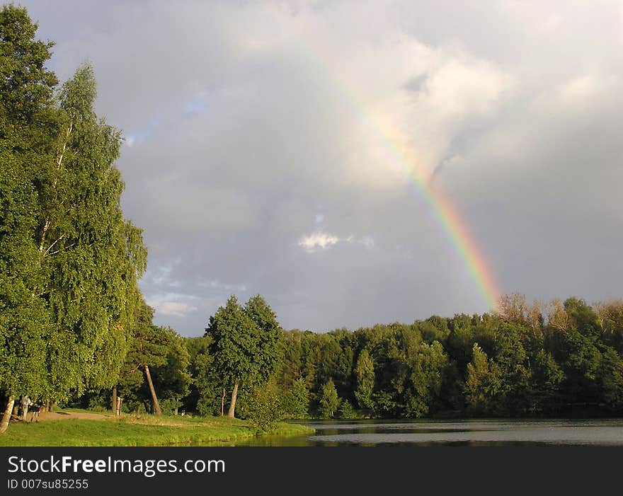 A rainbow over pond in a Moscow park