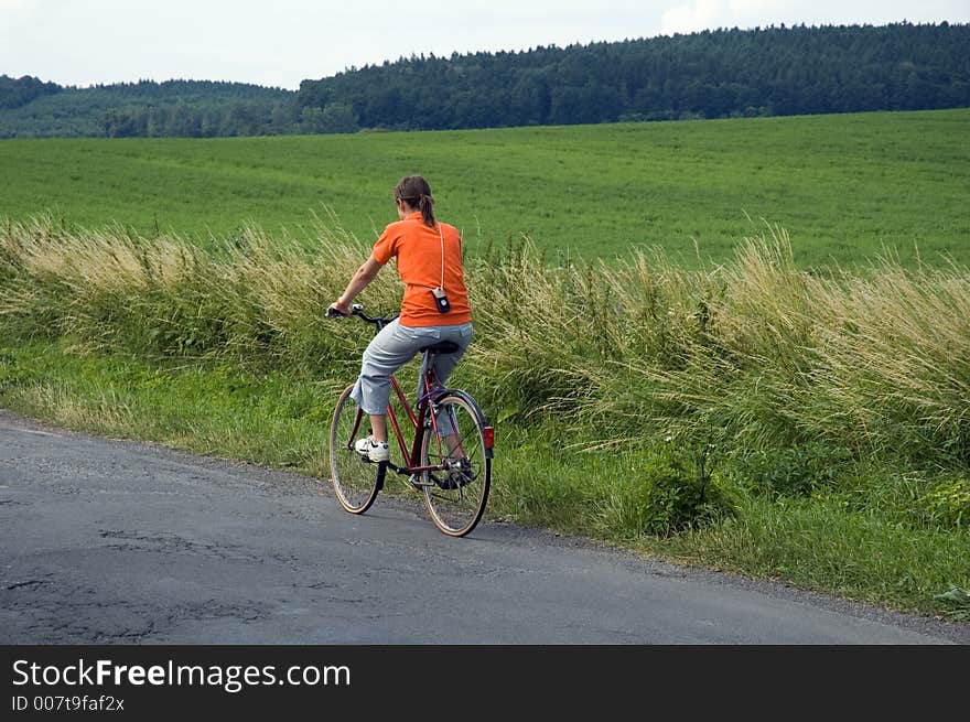 Girl riding bicycle in country