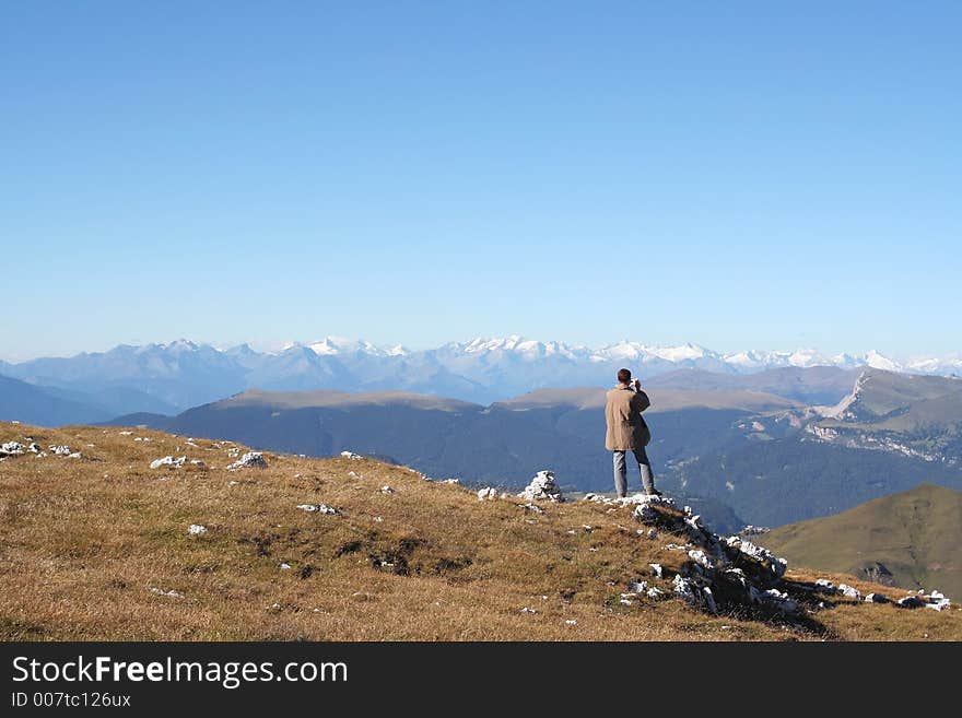 Man takes photo of breathtaking view,Dolomites,italy. Man takes photo of breathtaking view,Dolomites,italy