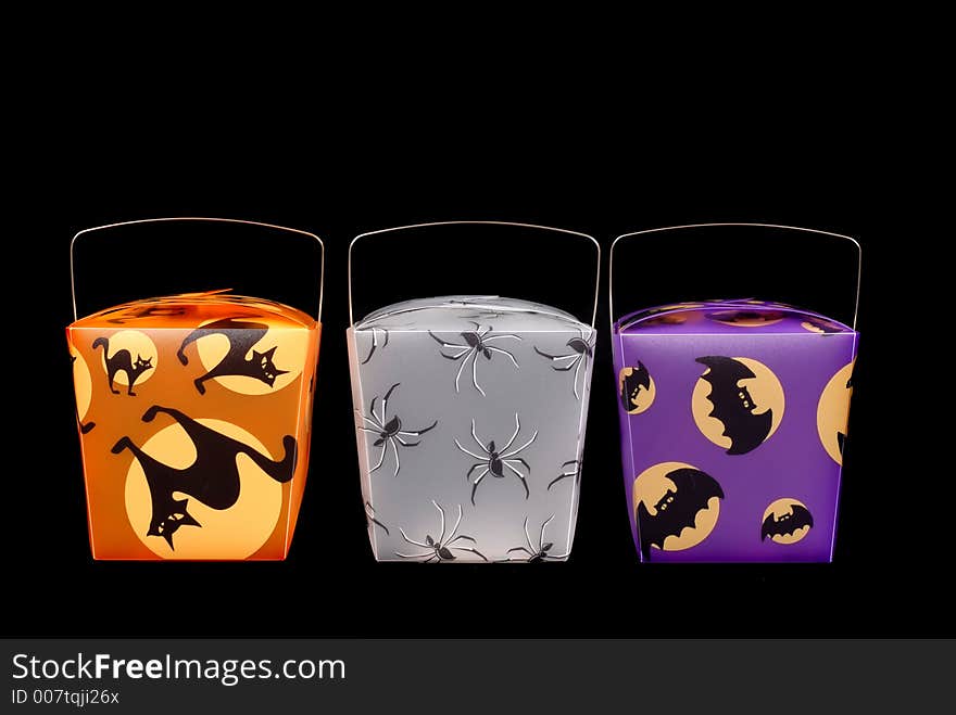 Colorful halloween candy carriers on black