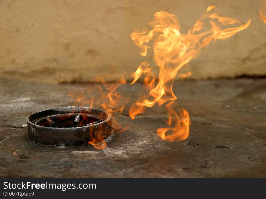 The image of fire in a metal washer