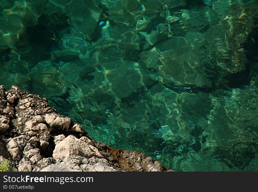 Pure sea water and a rock