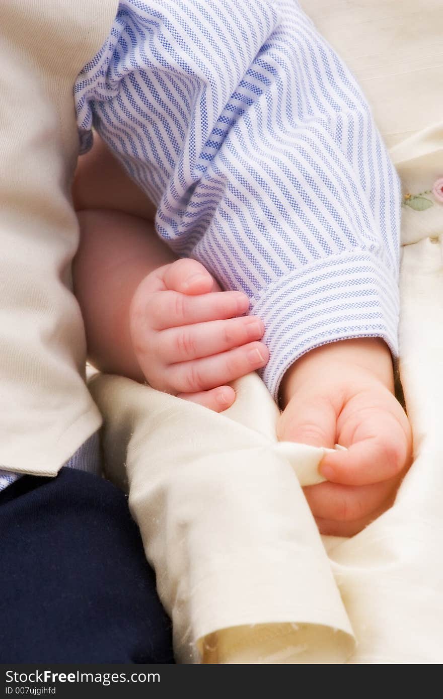 Arms and hands of two children linked together. Arms and hands of two children linked together.