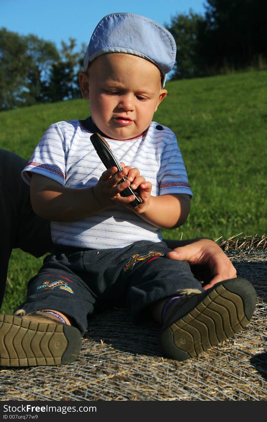 Small child playing with mobile phone. Small child playing with mobile phone.